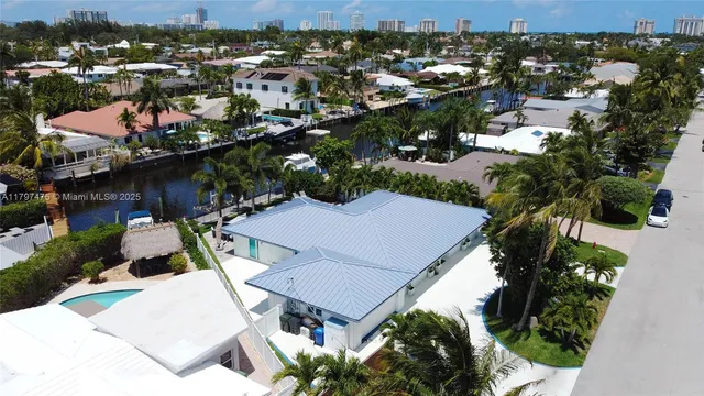 an aerial view of a house with a yard