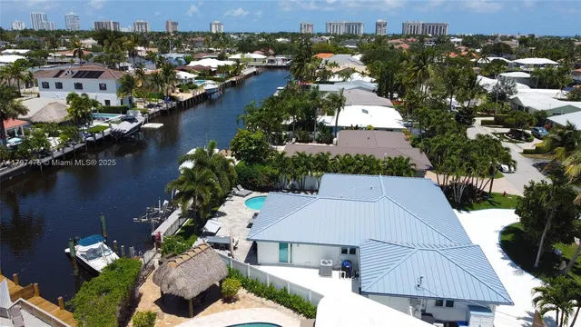 an aerial view of house with yard and ocean view