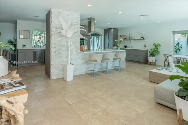 a large kitchen with kitchen island granite countertop a sink and cabinets