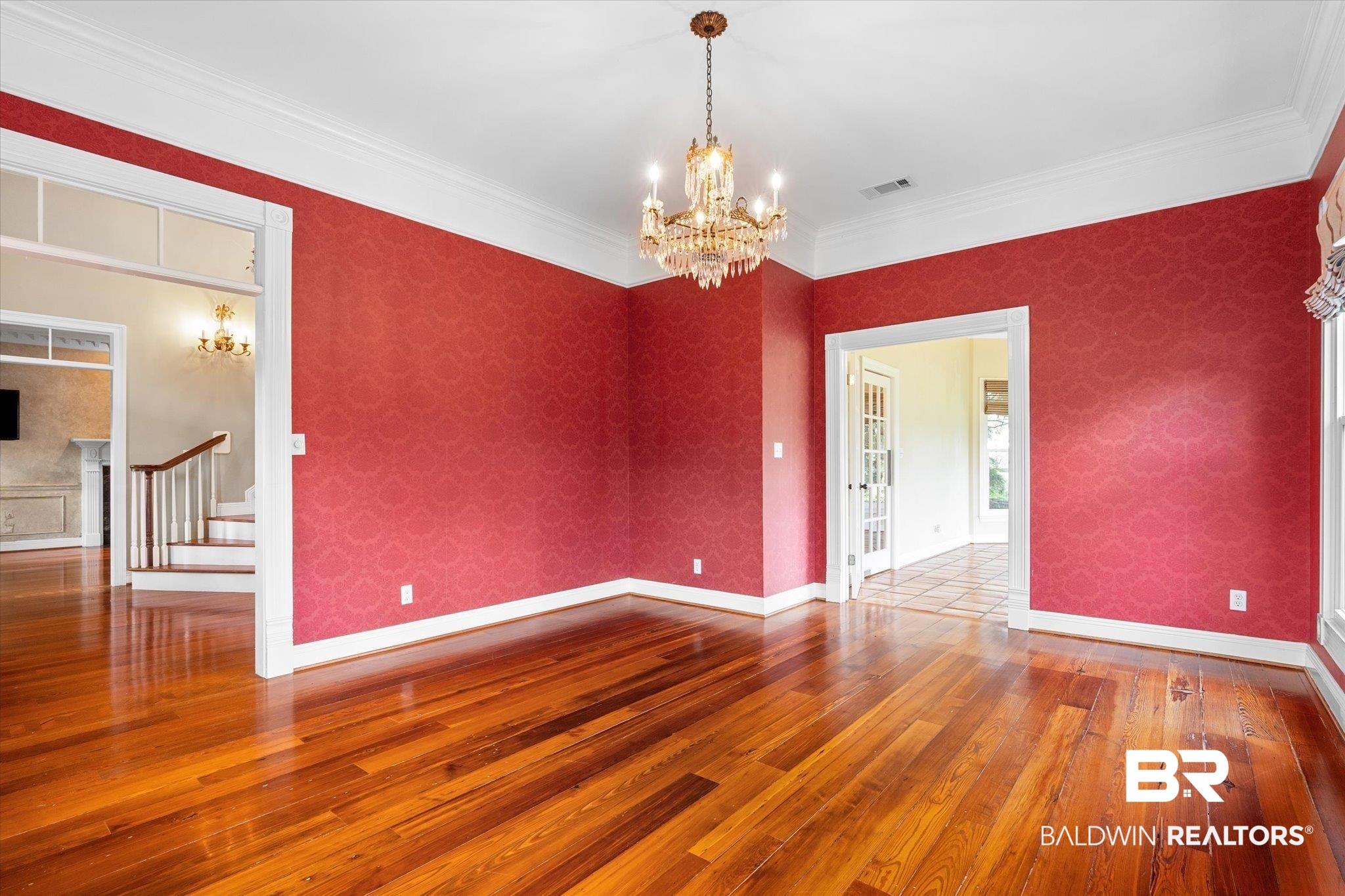 5231 Dawes Road Grand Bay, AL 36541 - Photo 7 of 49 Unfurnished room featuring ornamental molding, hardwood / wood-style floors, and a notable chandelier