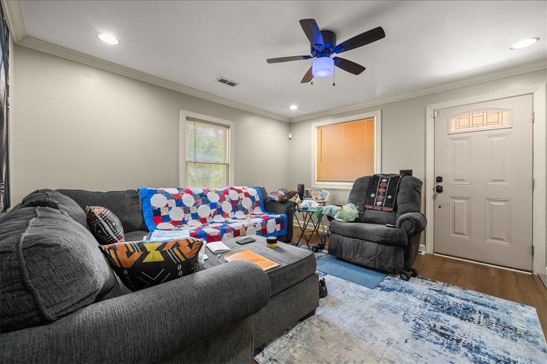 412 Sanders Street Anderson, SC 29624 - Photo 5 of 30 A comfortable living space featuring hardwood flooring and natural illumination.