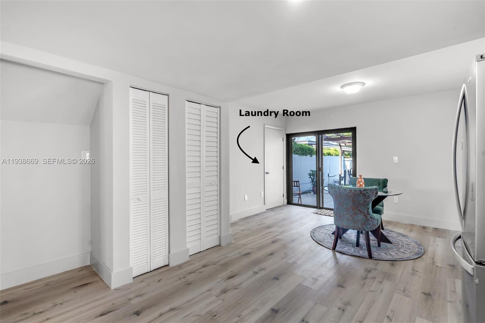 8773 Southwest 36th Street Miami, FL 33165 - Photo 11 of 47 a view of a room with wooden floor lounge chair and windows