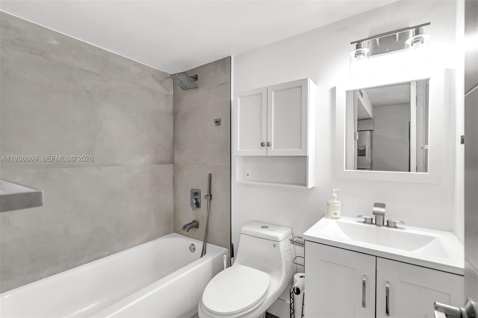 8773 Southwest 36th Street Miami, FL 33165 - Photo 13 of 47 a bathroom with a sink toilet vanity and bathtub