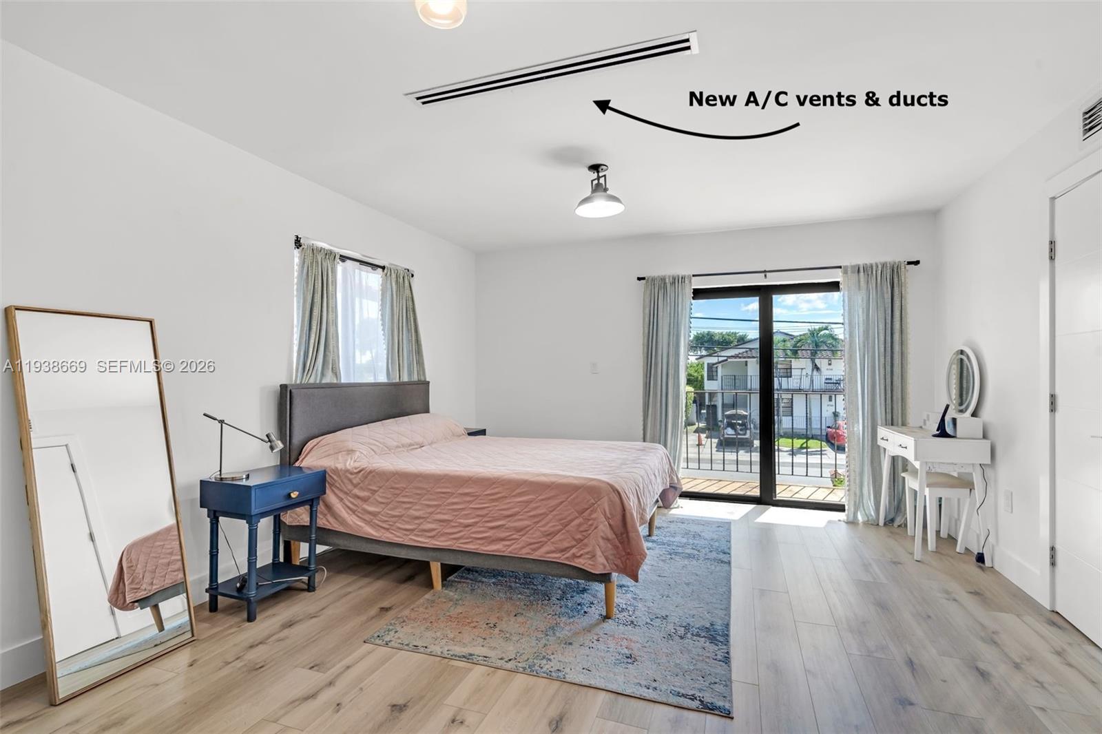 8773 Southwest 36th Street Miami, FL 33165 - Photo 15 of 47 a bedroom with a bed and a large window