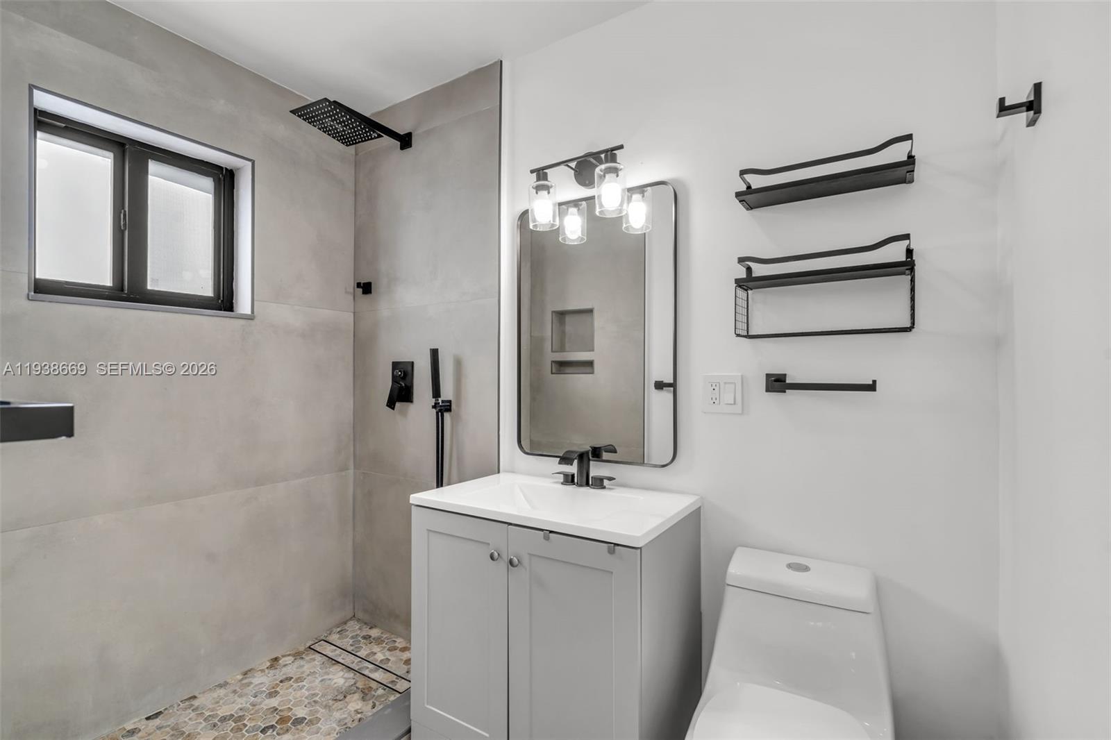 8773 Southwest 36th Street Miami, FL 33165 - Photo 18 of 47 a bathroom with a sink a toilet and mirror