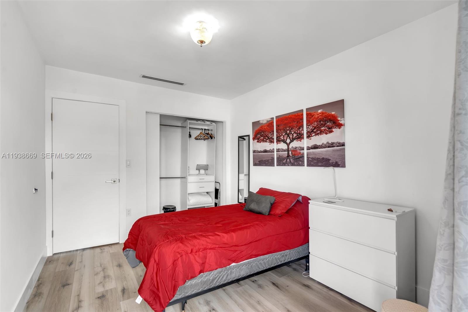 8773 Southwest 36th Street Miami, FL 33165 - Photo 22 of 47 a bedroom with a bed and a painting on the wall