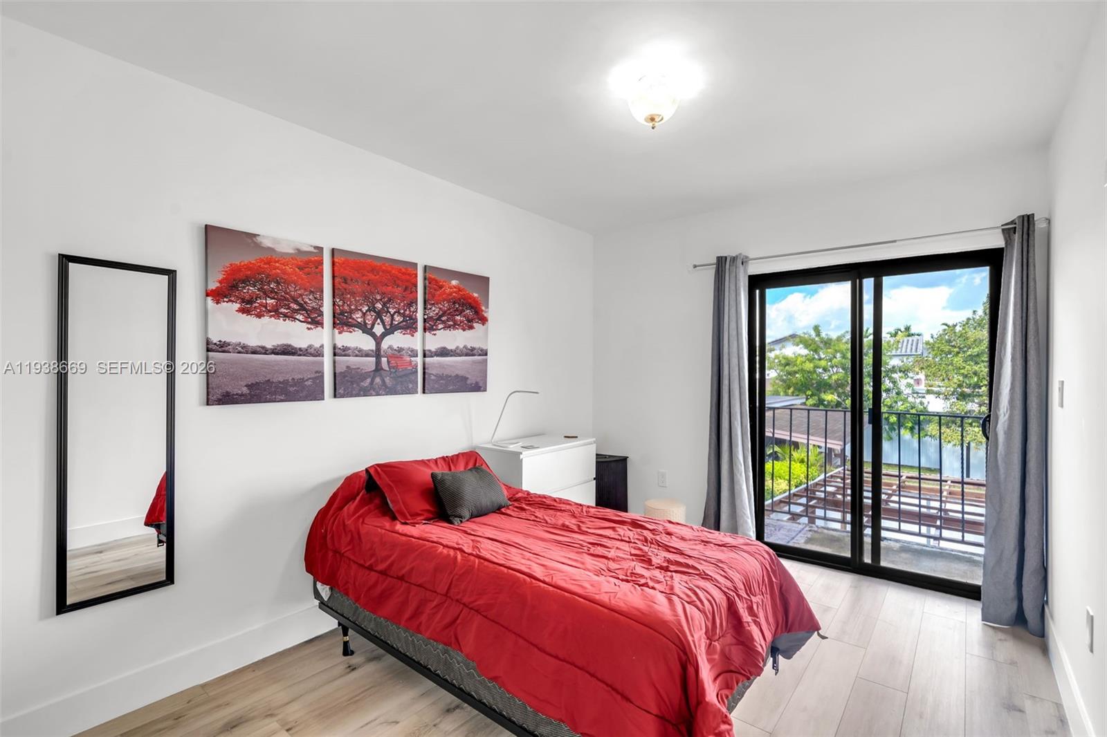 8773 Southwest 36th Street Miami, FL 33165 - Photo 23 of 47 a bedroom with a bed and a large window