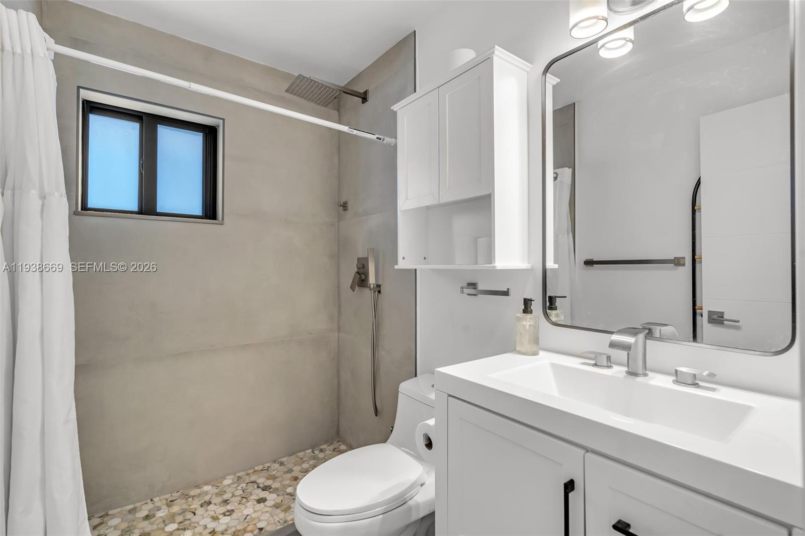 8773 Southwest 36th Street Miami, FL 33165 - Photo 24 of 47 a bathroom with a sink a toilet and shower
