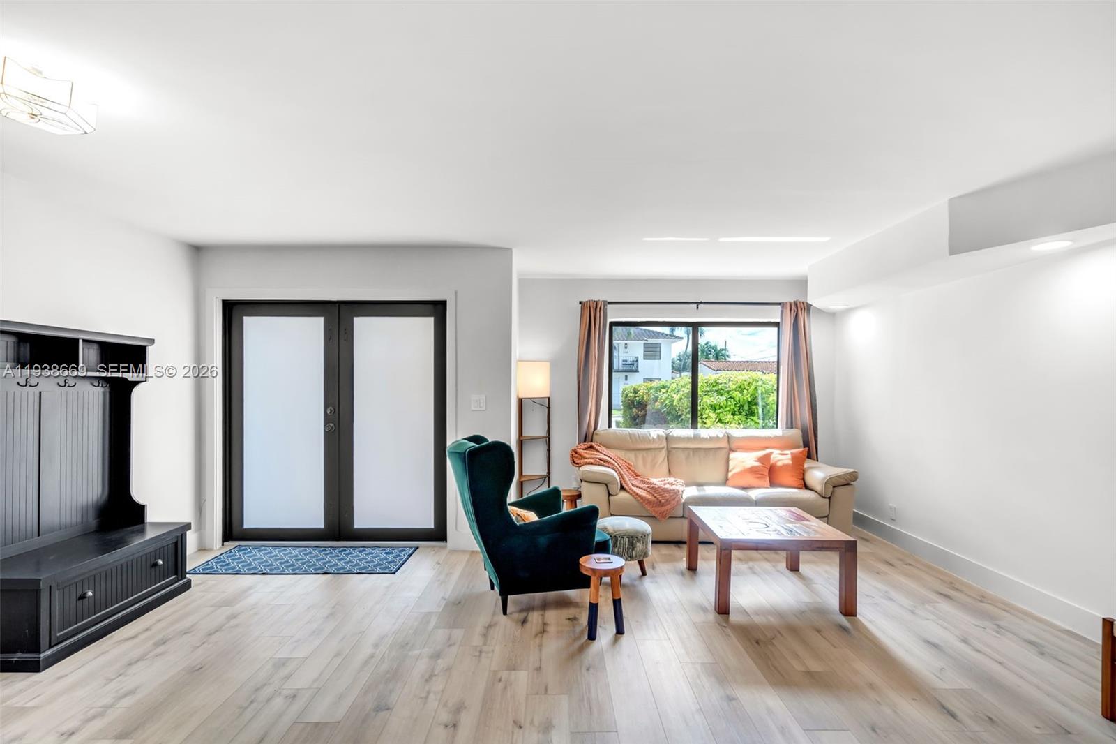 8773 Southwest 36th Street Miami, FL 33165 - Photo 3 of 47 a living room with furniture a large window and a flat screen tv