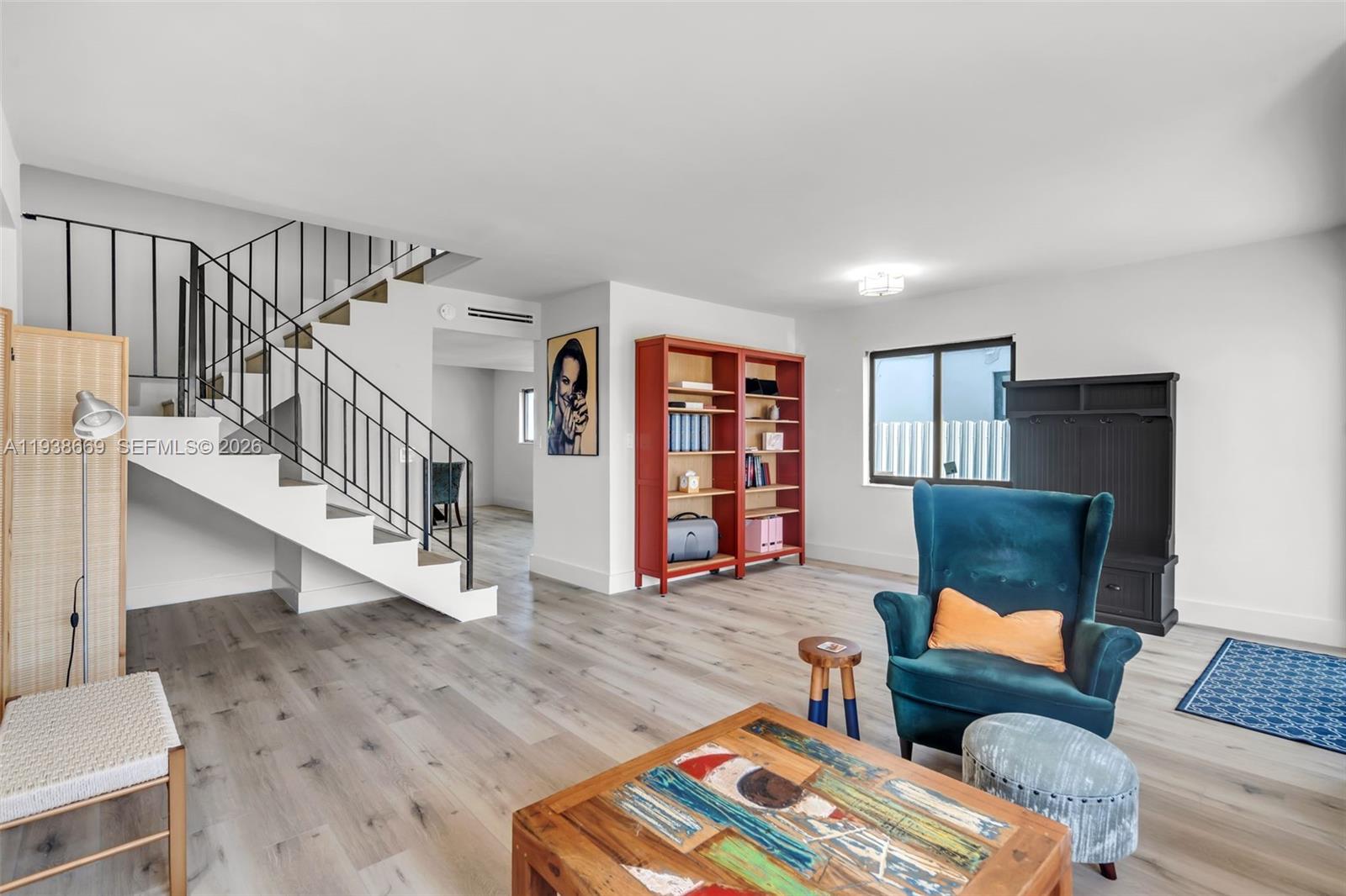 8773 Southwest 36th Street Miami, FL 33165 - Photo 6 of 47 a living room with furniture and a book shelf