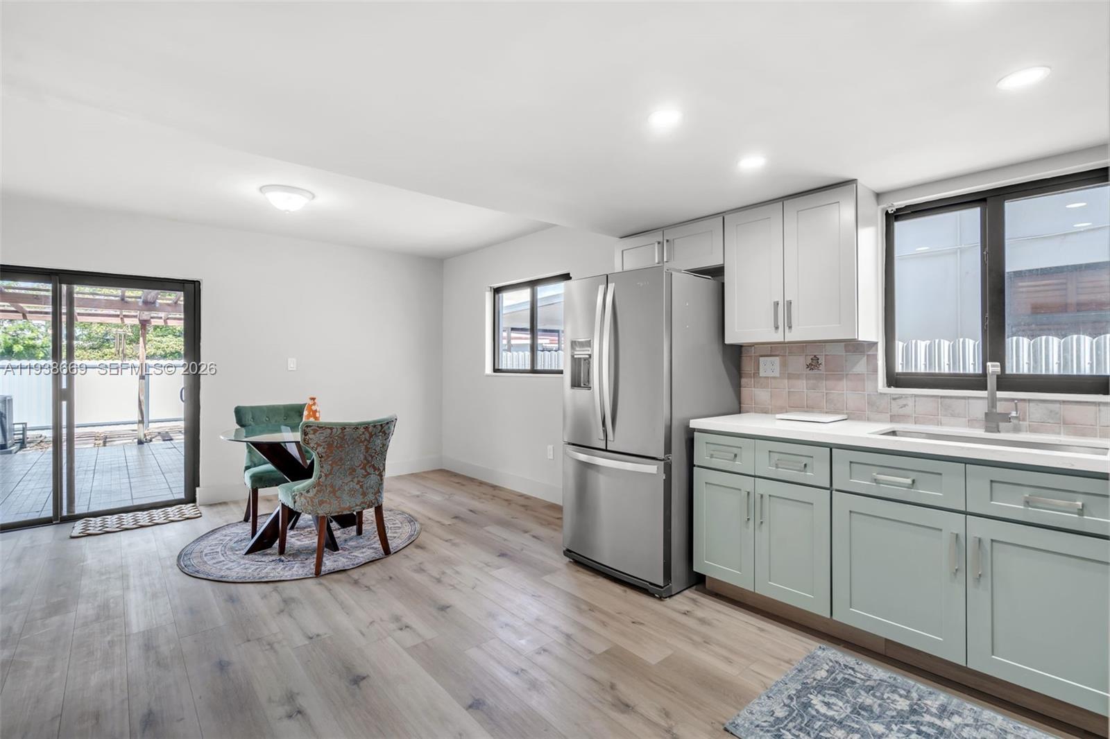 8773 Southwest 36th Street Miami, FL 33165 - Photo 7 of 47 a kitchen with sink cabinets and dining table
