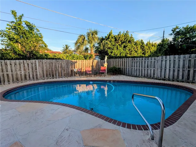 a view of a backyard with furniture and a tub