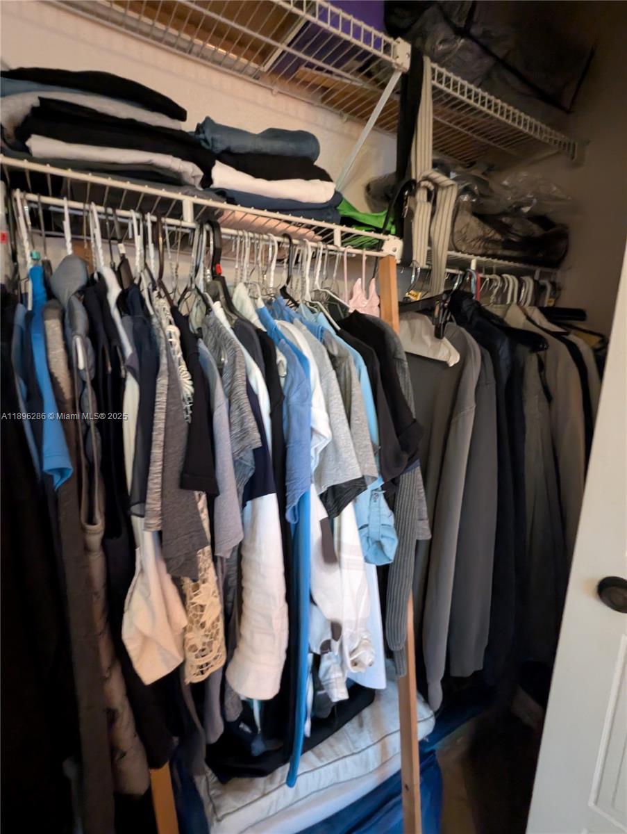 3031 Northwest 74th Avenue Hollywood, FL 33024 - Photo 28 of 34 a view of walk in closet with clothes and shoes