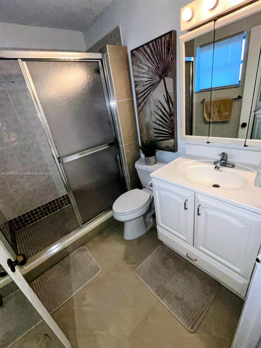 3031 Northwest 74th Avenue Hollywood, FL 33024 - Photo 29 of 34 a bathroom with a sink a toilet and a mirror