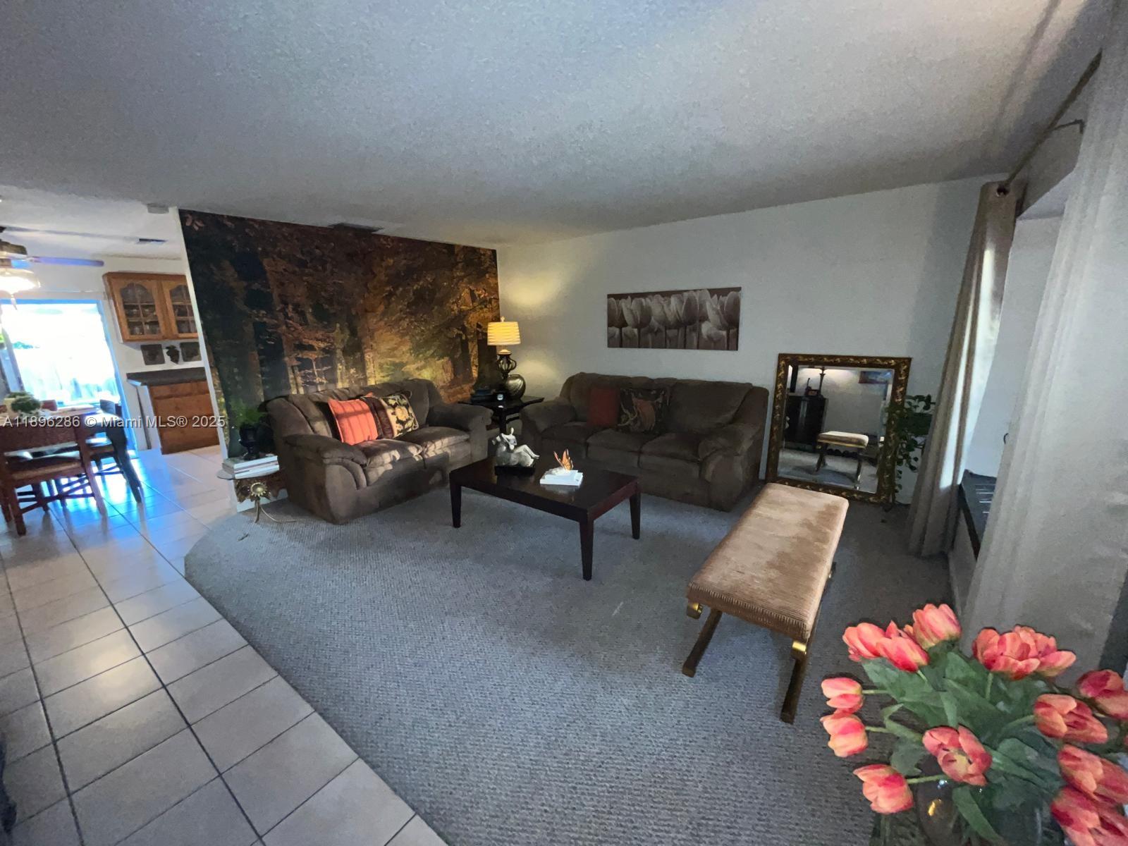 3031 Northwest 74th Avenue Hollywood, FL 33024 - Photo 5 of 34 a living room with furniture and a flat screen tv