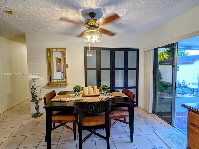 a dining room with wooden floor and a chandelier