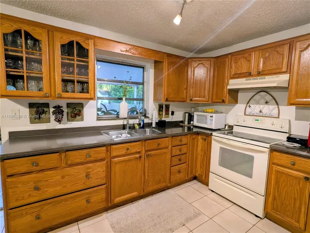 a kitchen with stainless steel appliances granite countertop a sink and cabinets