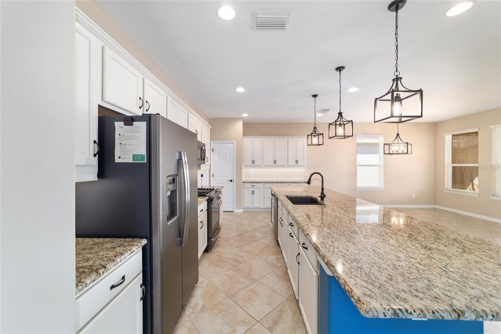 5670 Northwest 39th Lane Ocala, FL 34482 - Photo 11 of 61 a kitchen with stainless steel appliances granite countertop a sink refrigerator and cabinets