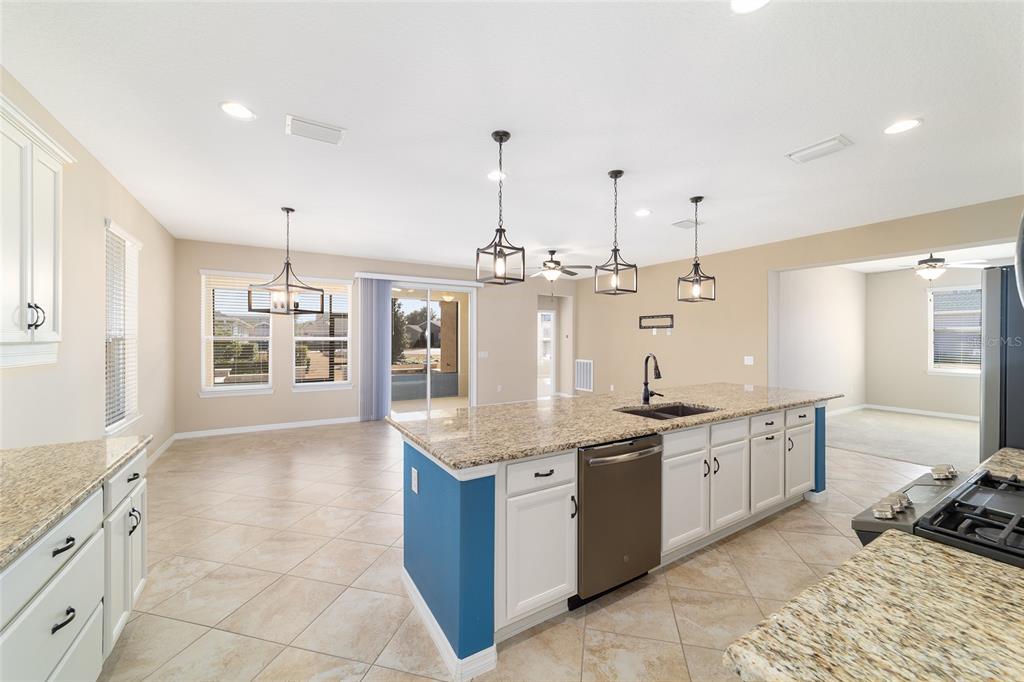 5670 Northwest 39th Lane Ocala, FL 34482 - Photo 20 of 61 a large kitchen with kitchen island a large counter space a sink appliances and cabinets