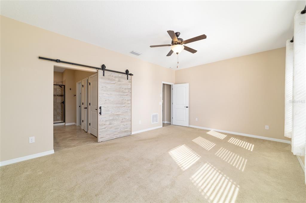 5670 Northwest 39th Lane Ocala, FL 34482 - Photo 22 of 61 a view of empty room with wooden floor and ceiling fan