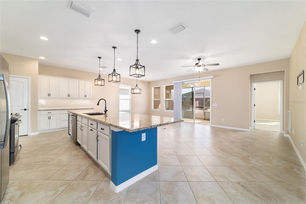 5670 Northwest 39th Lane Ocala, FL 34482 - Photo 4 of 61 a large kitchen with kitchen island granite countertop a large counter top and appliances