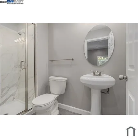 a bathroom with a sink toilet and a mirror