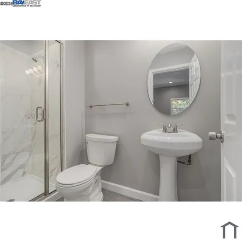 a bathroom with a sink toilet and a mirror