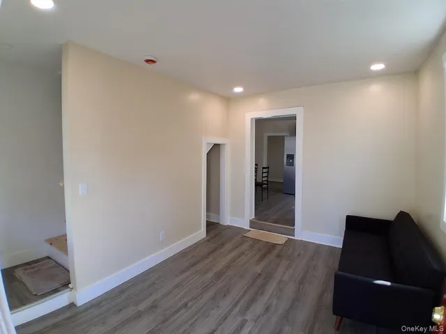a view of room with window and wooden floor