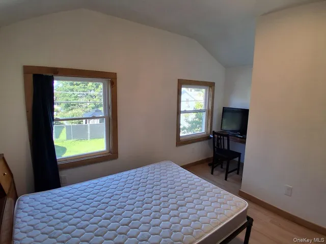 a bedroom with a bed and a window in it