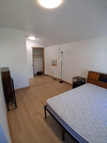 a bedroom with a bed and a chair