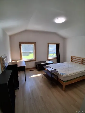a bedroom with bed and window