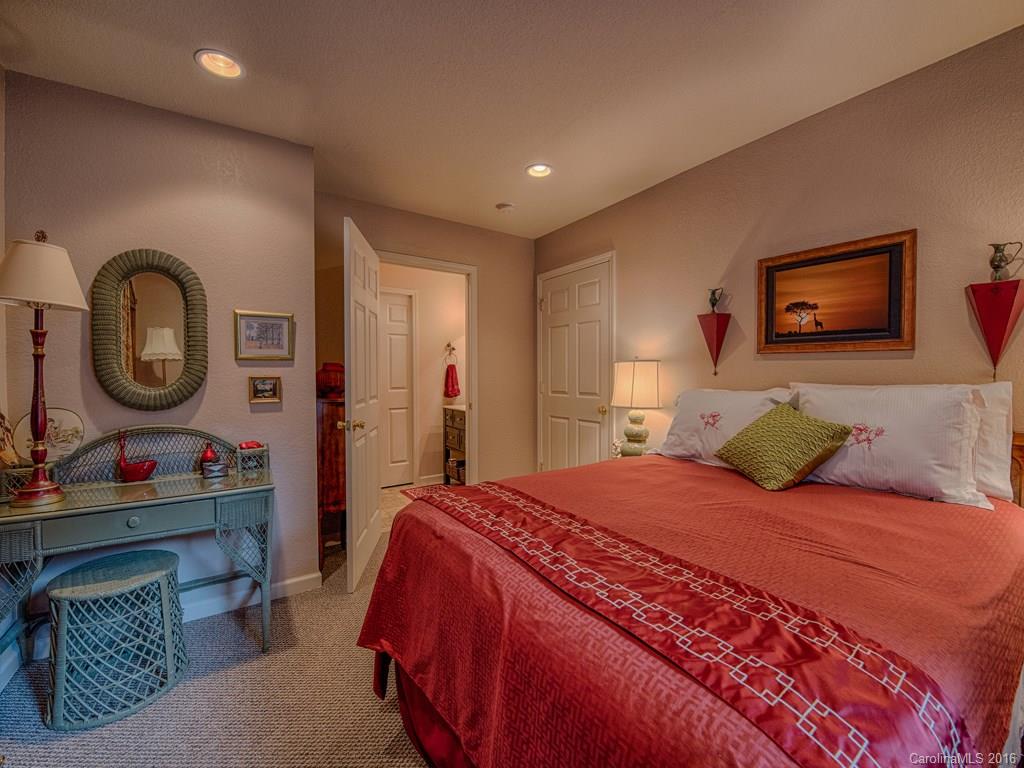541 Chinquapin Road Canton, NC 28716 - Photo 12 of 23 a bedroom with a bed a mirror and dresser