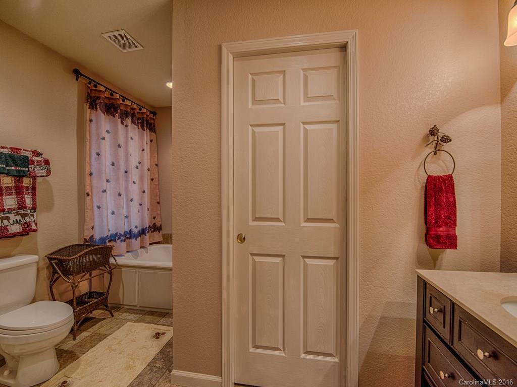 541 Chinquapin Road Canton, NC 28716 - Photo 14 of 23 a bathroom with a toilet sink and mirror