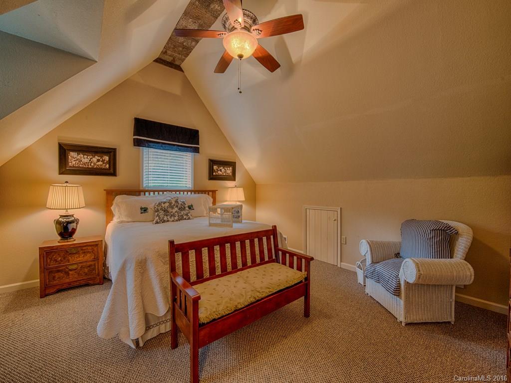 541 Chinquapin Road Canton, NC 28716 - Photo 18 of 23 a bedroom with a bed and a chandelier