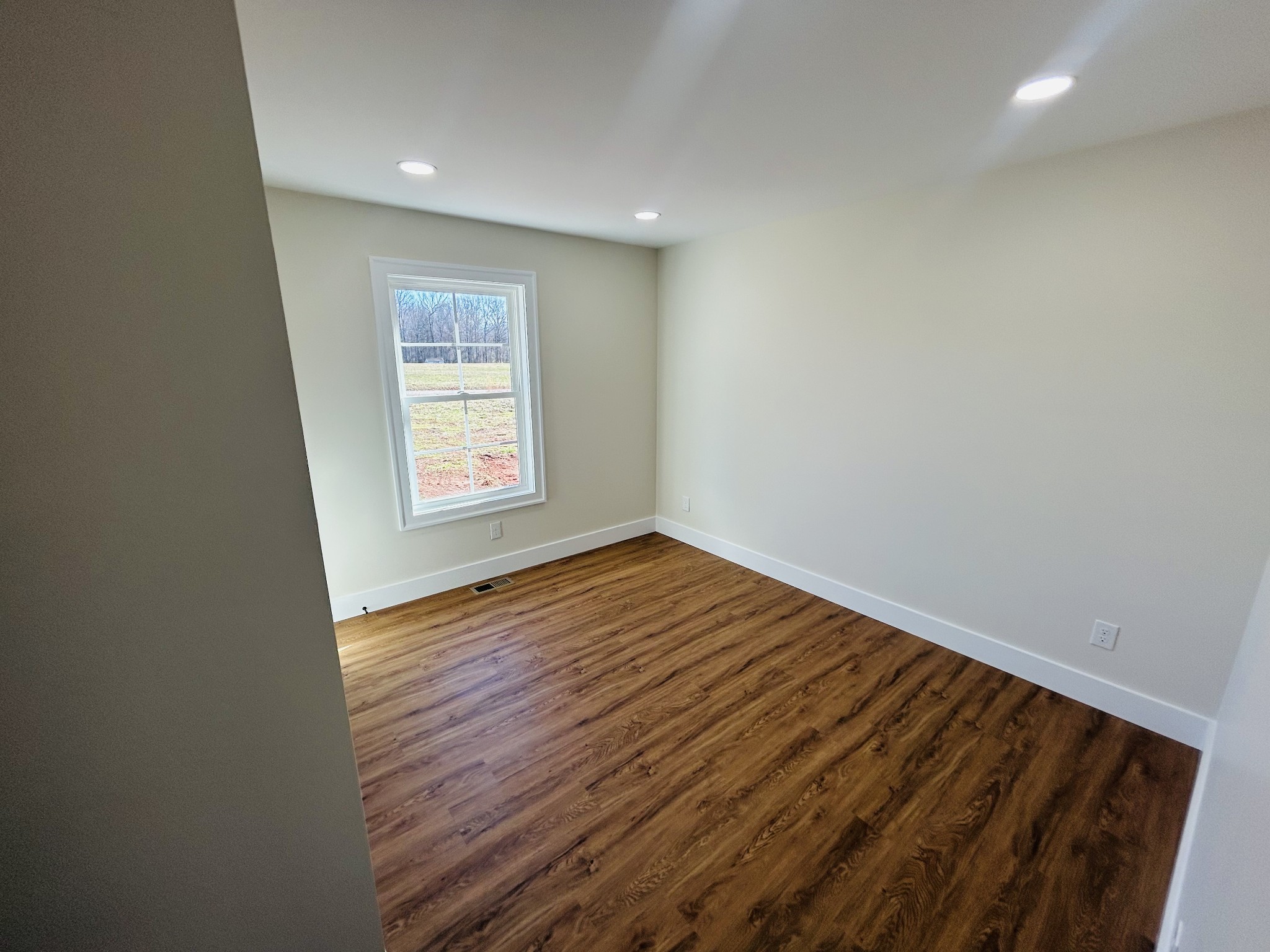 614 Haddon Lane Winchester, TN 37398 - Photo 11 of 12 an empty room with wooden floor and window