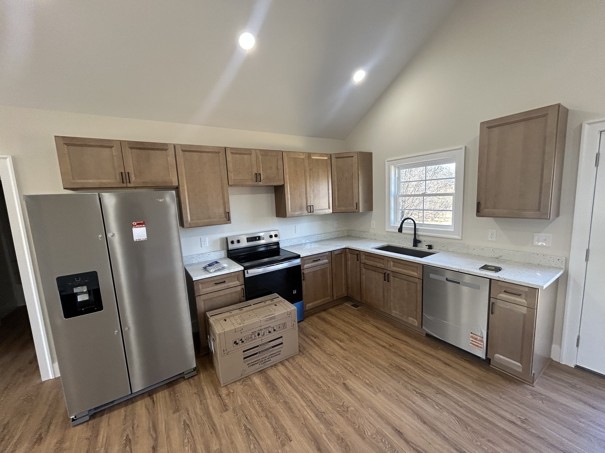 614 Haddon Lane Winchester, TN 37398 - Photo 3 of 12 a kitchen with stainless steel appliances a refrigerator a sink a stove a microwave a sink a refrigerator and cabinets