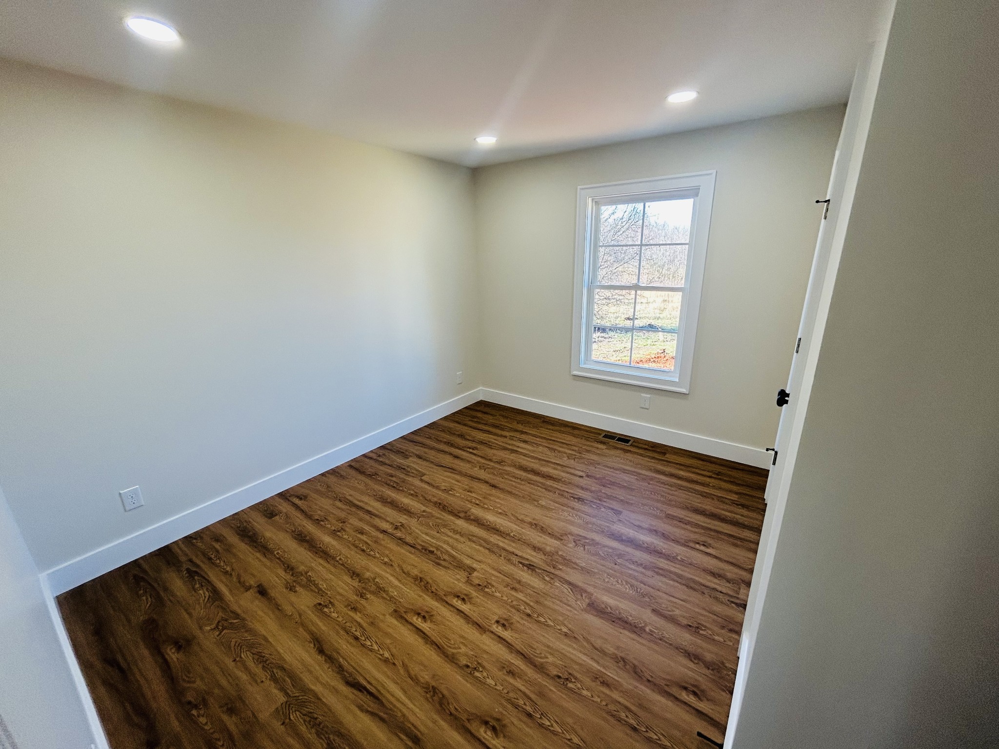 614 Haddon Lane Winchester, TN 37398 - Photo 5 of 12 an empty room with wooden floor and windows