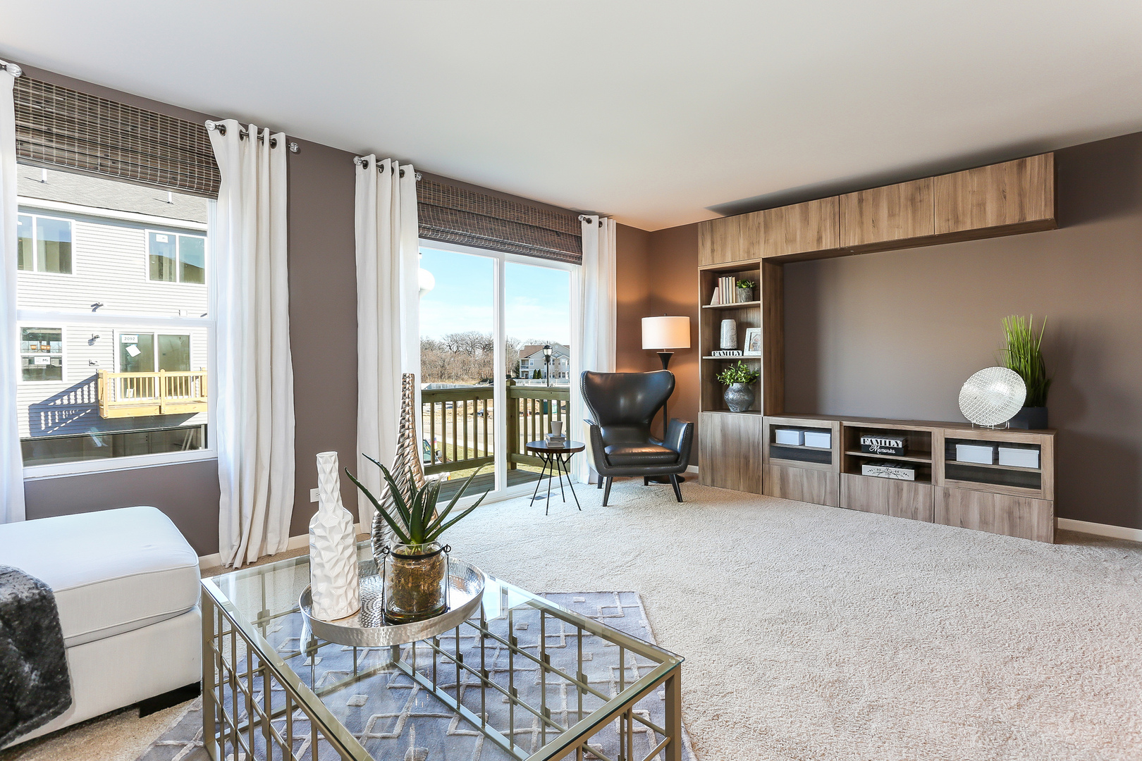 2350 Upland Road, Unit 2276 Pingree Grove, IL 60140 - Photo 5 of 18 a living room with furniture a flat screen tv and floor to ceiling window