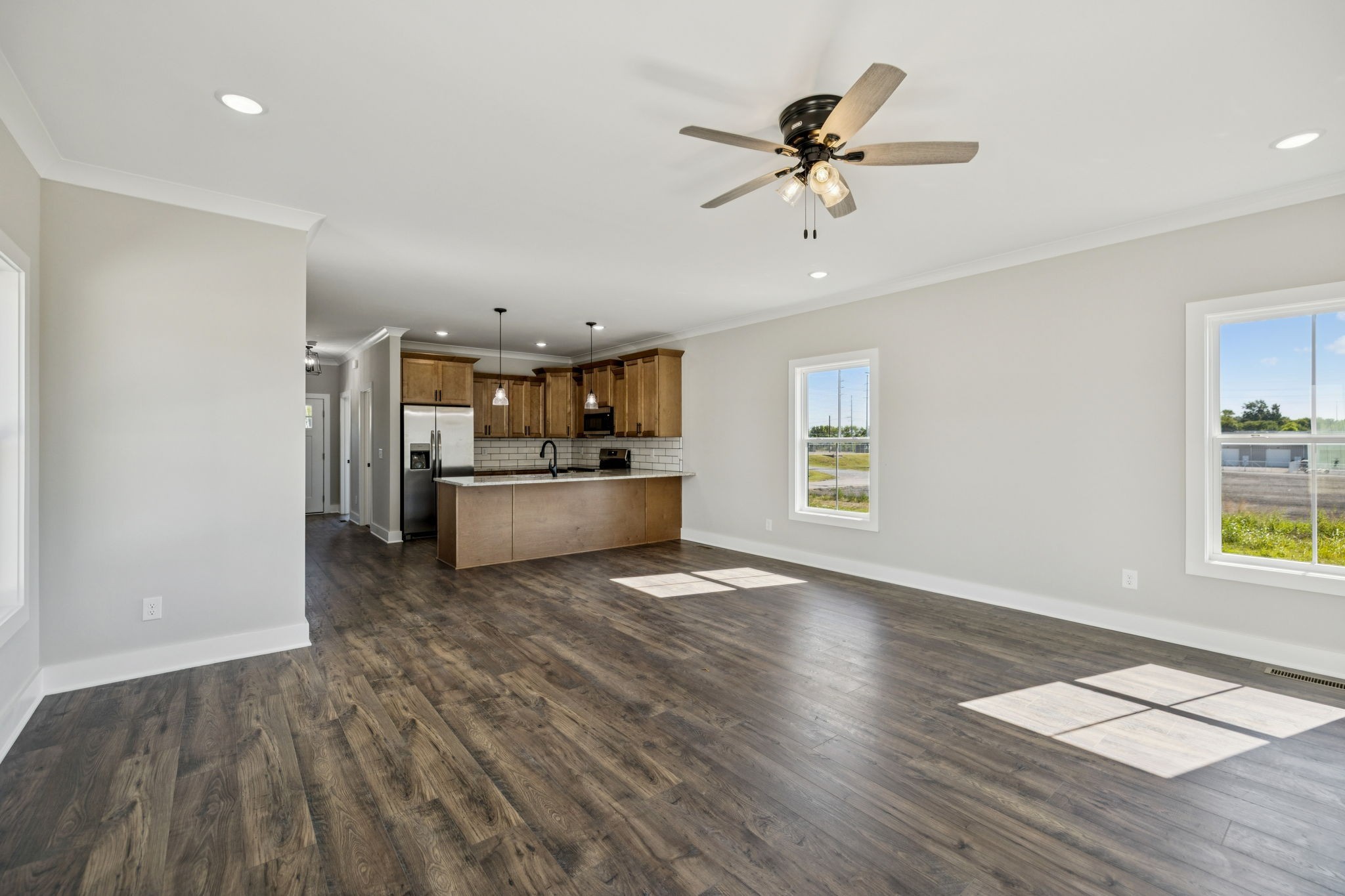 117 East Campbell Road, Unit A Madison, TN 37115 - Photo 12 of 29 a view of a kitchen with a sink dishwasher a refrigerator with wooden floor and a workspace