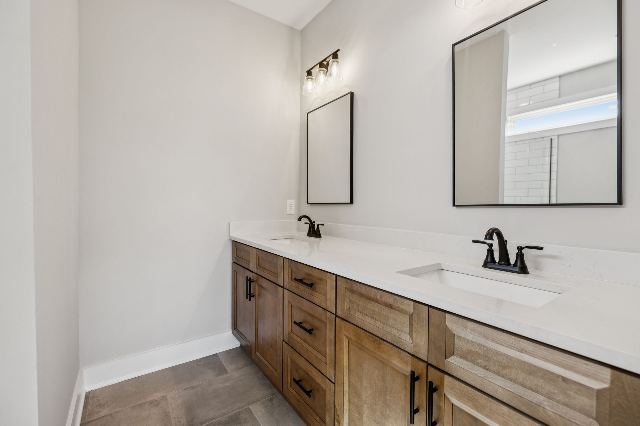 117 East Campbell Road, Unit A Madison, TN 37115 - Photo 20 of 29 a bathroom with a double vanity sink and mirror