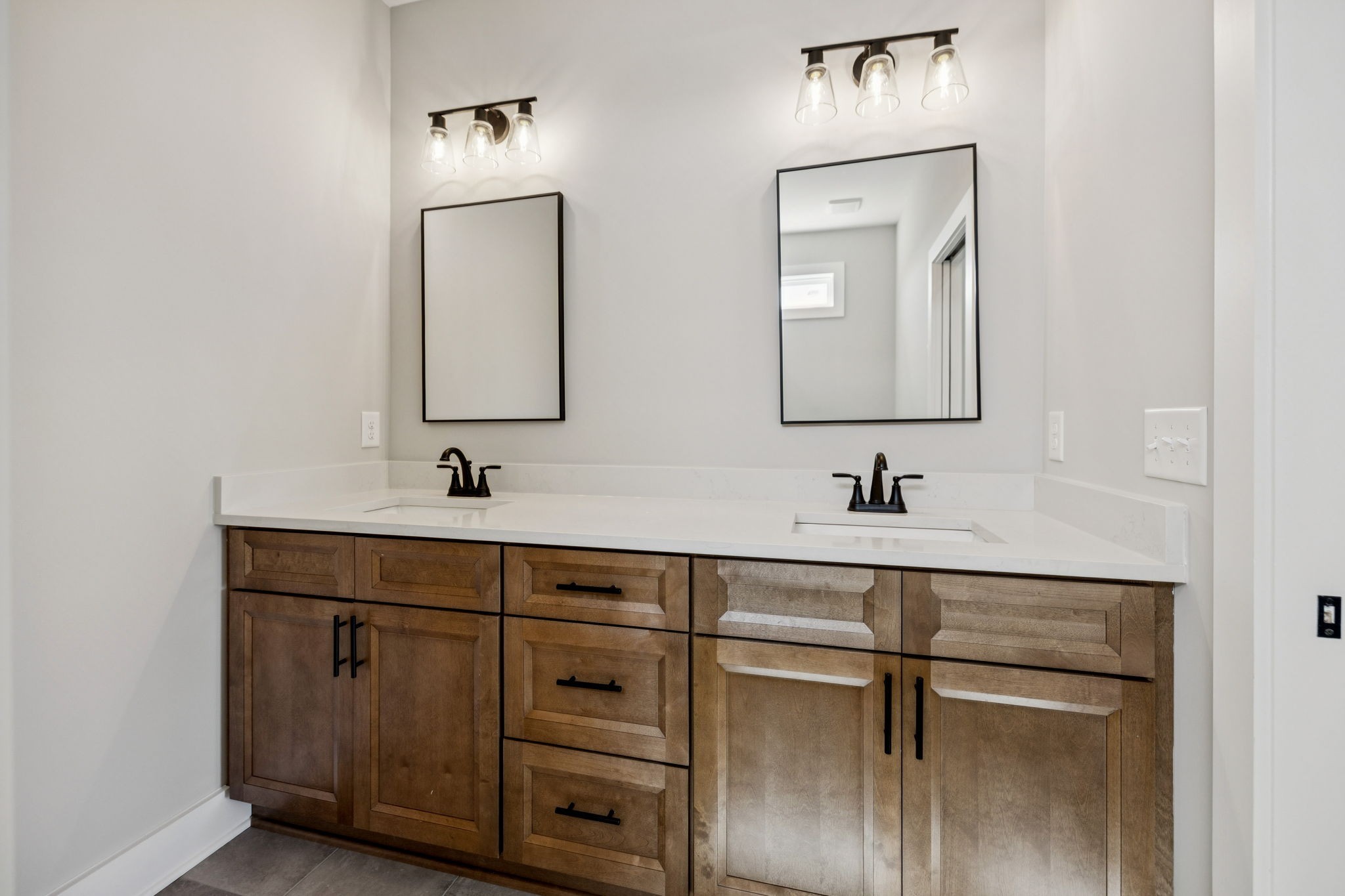 117 East Campbell Road, Unit A Madison, TN 37115 - Photo 23 of 29 a bathroom with a double vanity sink and mirror