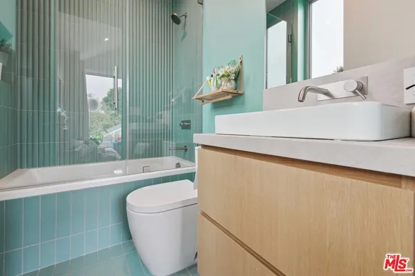 a childrens room with furniture and a floor to ceiling window