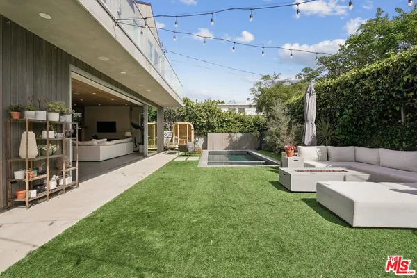 a view of an outdoor sitting area with furniture and garden