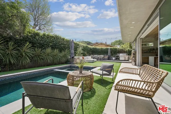 a backyard of a house with table and chairs