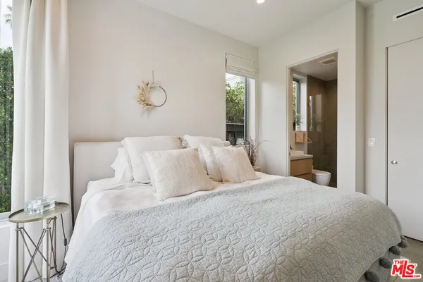 a large white bed in a white room