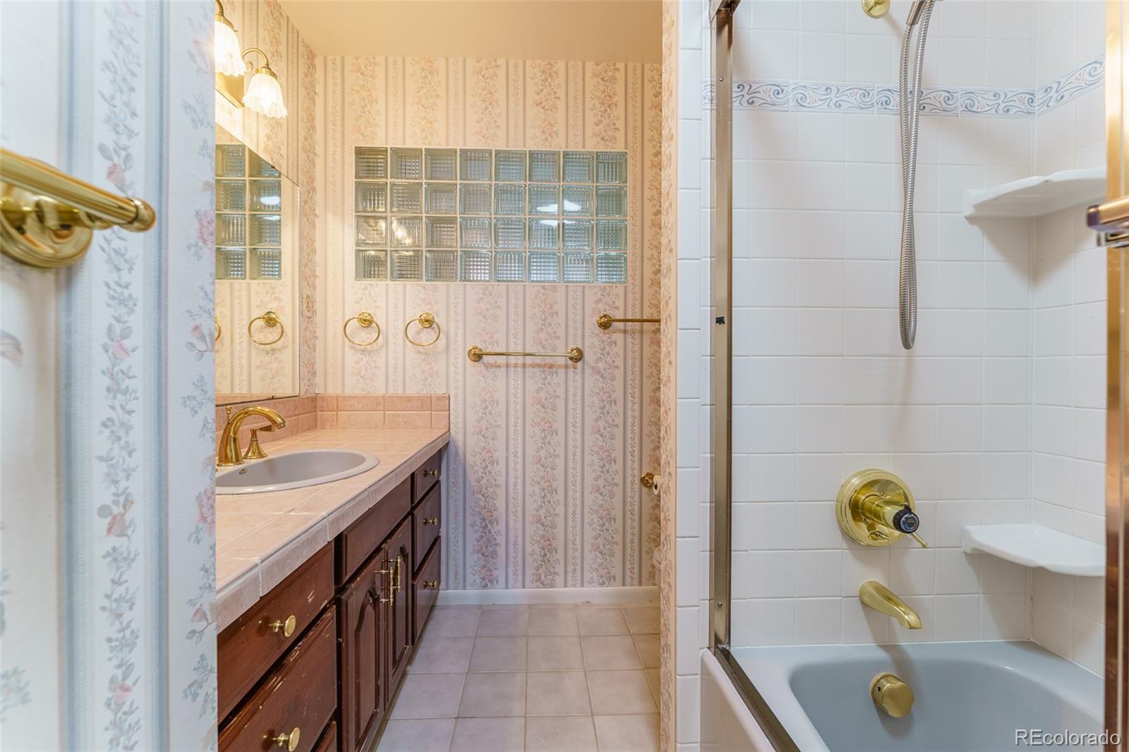 4184 Everett Drive Wheat Ridge, CO 80033 - Photo 14 of 22 a bathroom with a tub sink and mirror