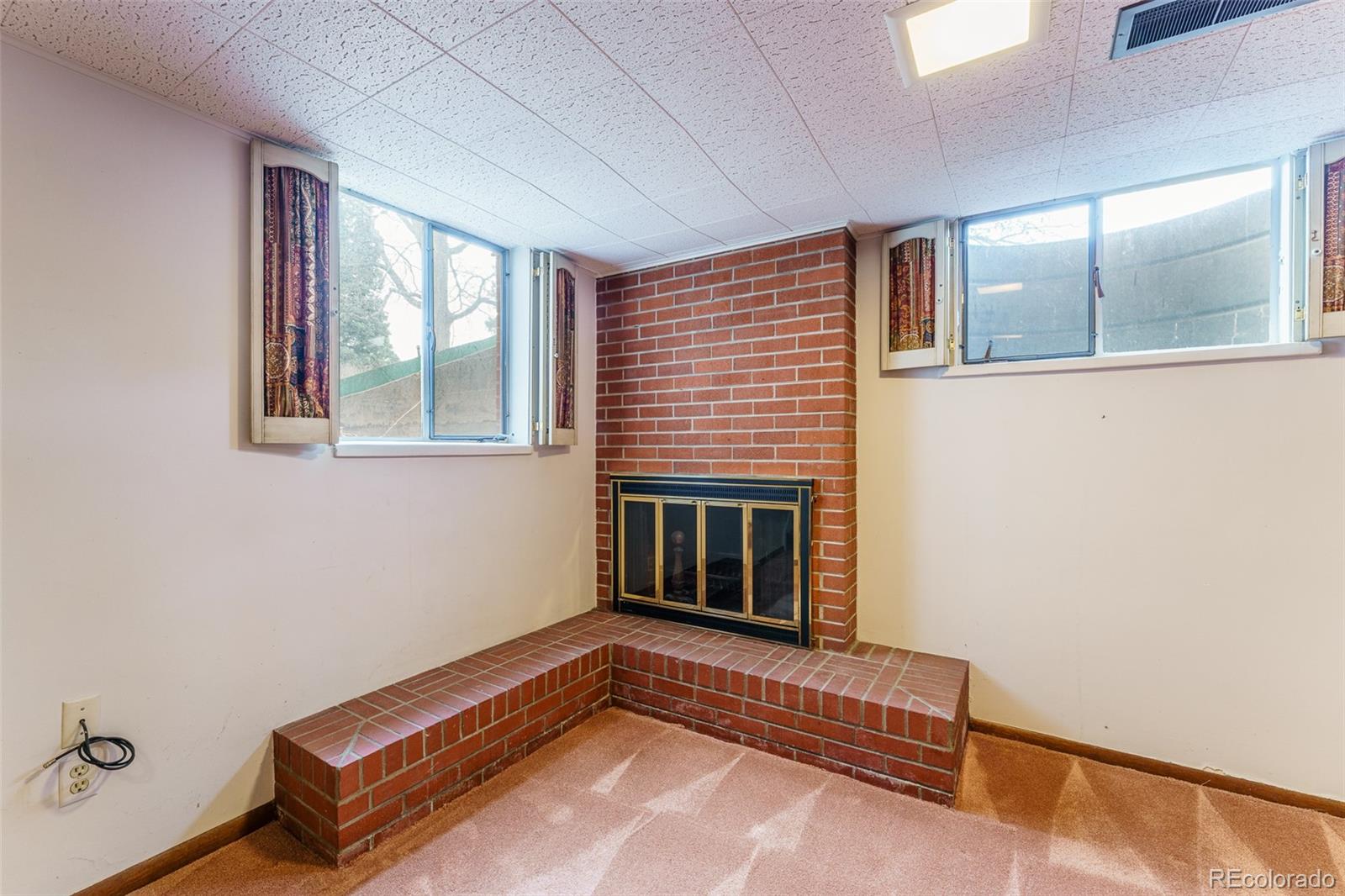 4184 Everett Drive Wheat Ridge, CO 80033 - Photo 16 of 22 a living room with a couch wooden floor and window