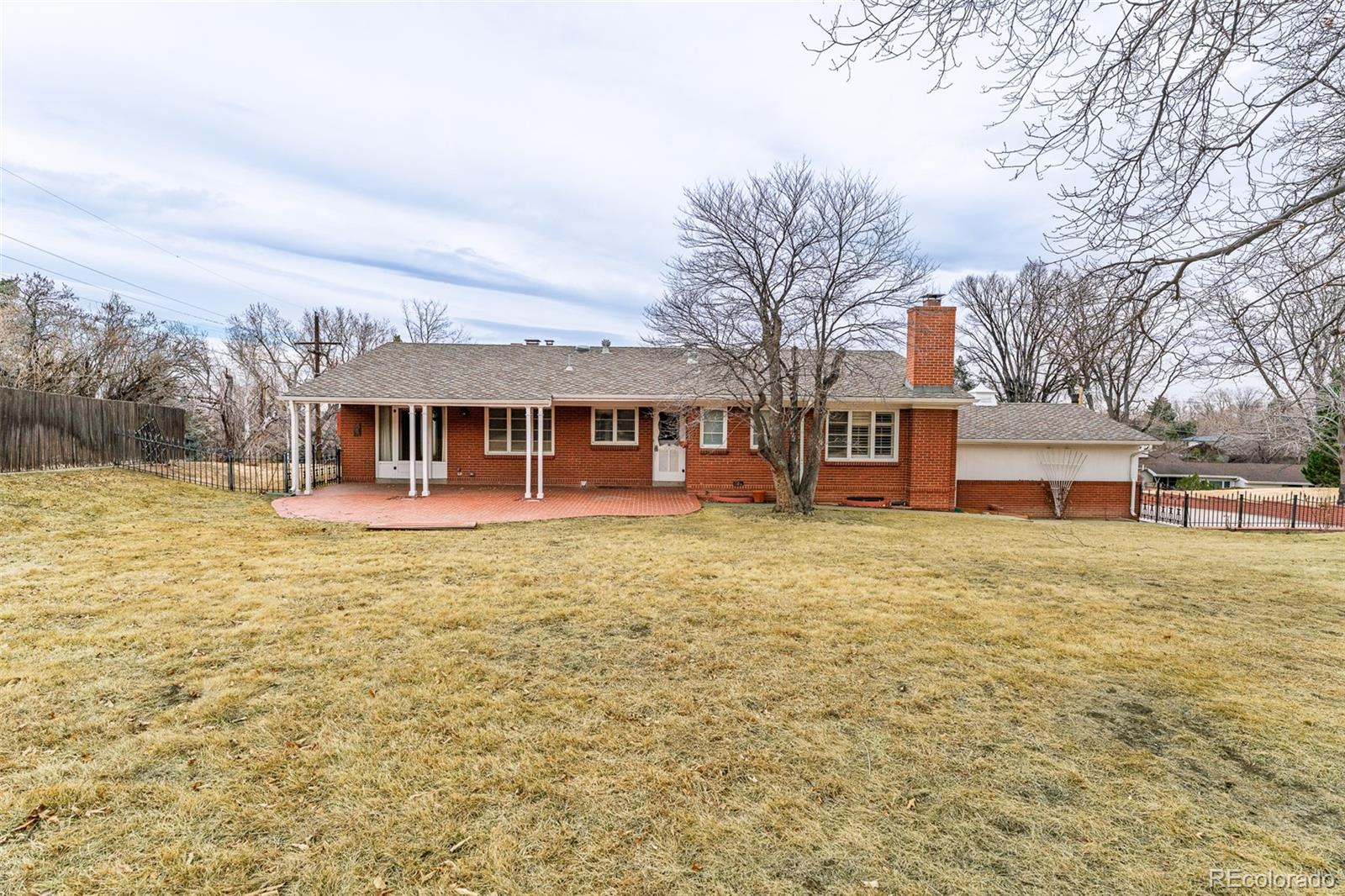 4184 Everett Drive Wheat Ridge, CO 80033 - Photo 21 of 22 a front view of a house with a garden