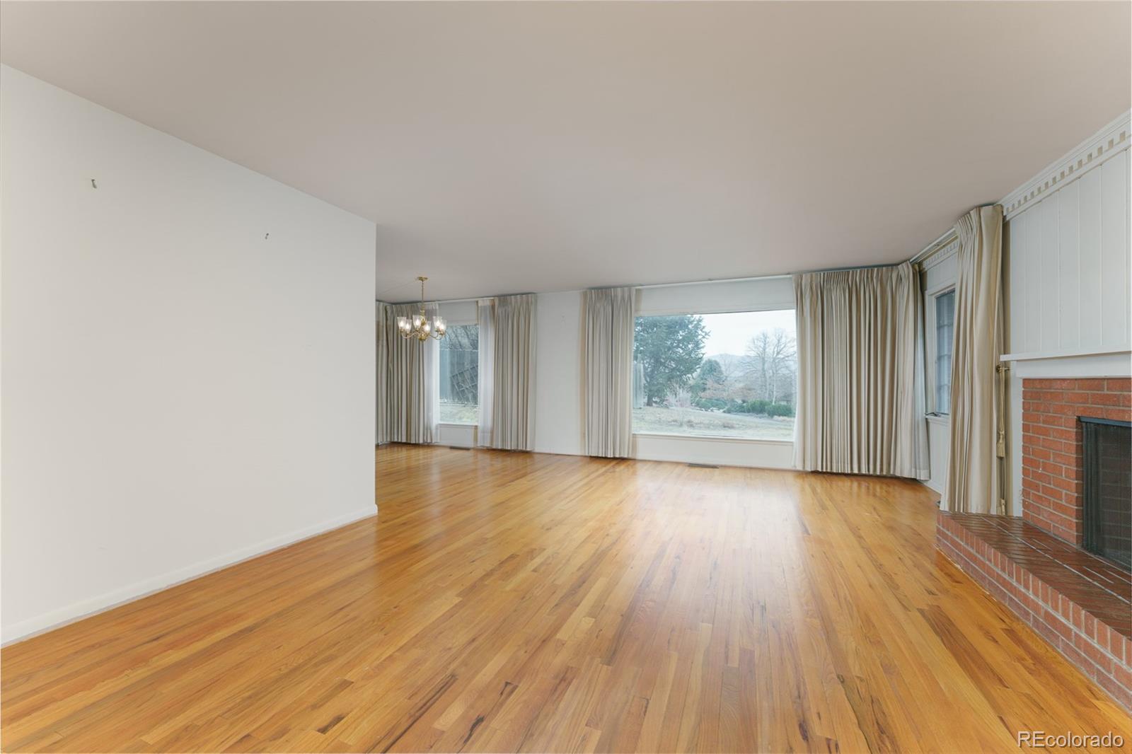 4184 Everett Drive Wheat Ridge, CO 80033 - Photo 7 of 22 wooden floor in an empty room with a window