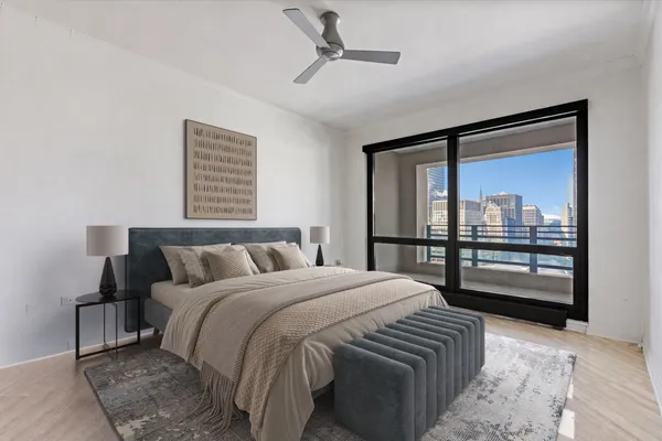 a bedroom with a bed and a painting on the wall